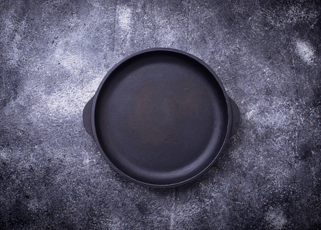 Cast iron frying pan with herbs and spicesの写真素材