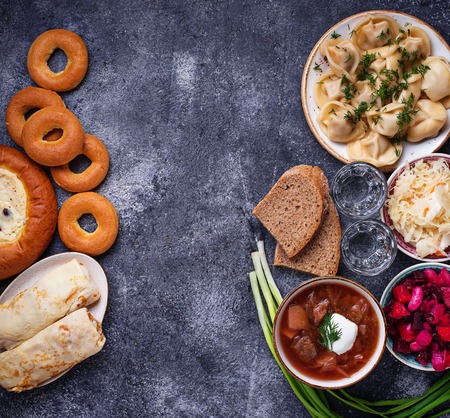 Traditional Russian food. Borscht, pelmeni, vinaigrette sauerkraut vodka and sweetsの写真素材