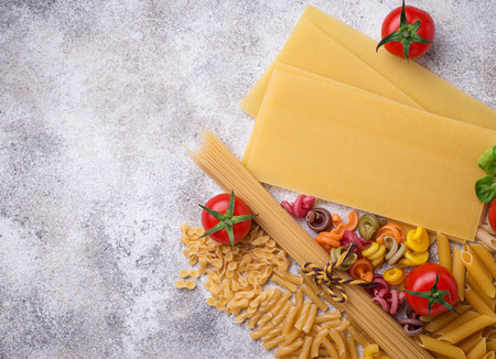 Various type of pasta and cherry tomato. Top view