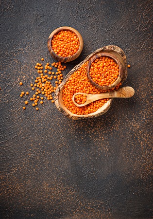 Bowl with red lentils on rusty background. Top viewの写真素材