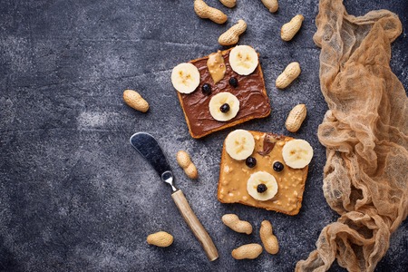 Breakfast for kids. Sandwiches with peanut butter in shape of bear. Top viewの写真素材
