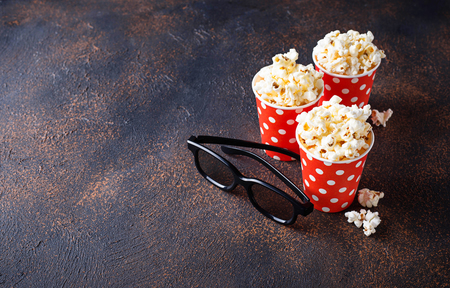 Popcorn with 3d glasses on dark backgroundの写真素材