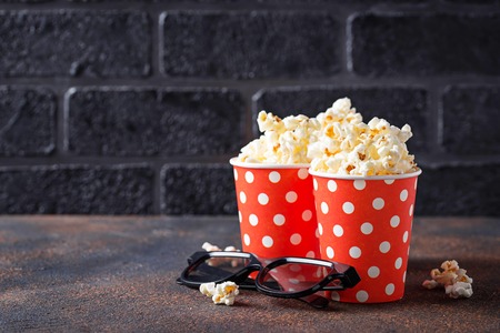 Popcorn with 3d glasses on dark backgroundの写真素材