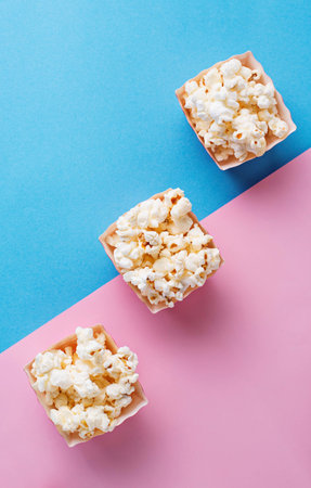 Popcorn  on blue and pink backgroundの写真素材