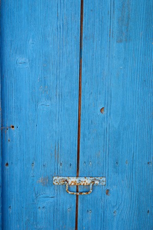 Old rustic crackled wooden door with knobの写真素材