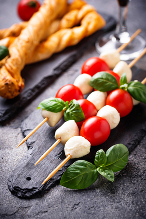 Caprese skewers and grissini breadの写真素材