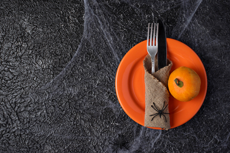 Halloween table setting with plate and webの写真素材