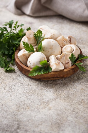 Raw fresh mushrooms in a wooden bowl. Selective focusの写真素材