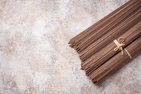 Raw uncooked Japanese soba noodles on light bacgroundの写真素材