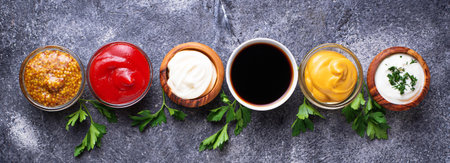 Set of different sauces. Ketchup, mayonnaise, mustard, soy sauce and tartar. Top view. Banner for...