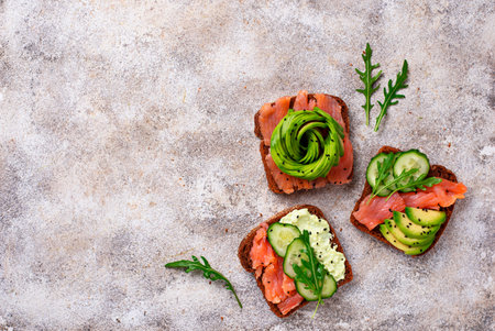 Avocado toast with salmon on rye bread