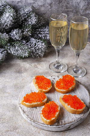 Toasts with red salmon caviar and champagneの写真素材