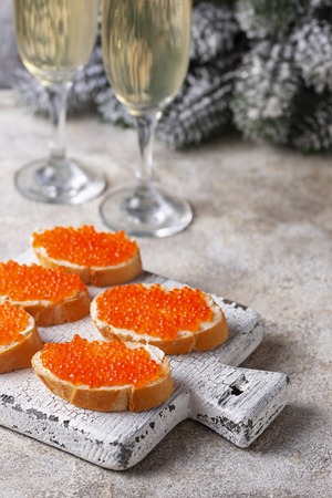 Toasts with red salmon caviar and champagneの写真素材