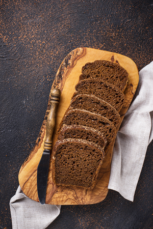 Fresh sliced rye bread on dark rusty backgroundの写真素材