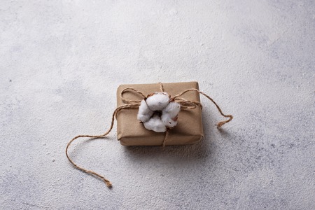 Gift box in craft paper decoration with cotton flowerの写真素材