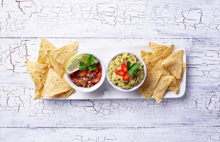 Guacamole, tomato sauce salsa and chips nachosの写真素材