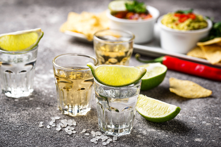 Shots of silver and gold tequilaの写真素材