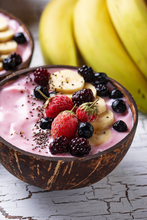 Frozen dessert nice cream with acai berry in coconut bowlの写真素材