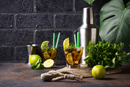 Cuba libre cocktail with mint, lime and iceの写真素材