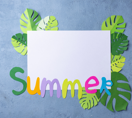 Summer background with monstera leaves from paper. Top viewの写真素材