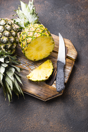 Fresh ripe sliced pineapple on cutting boardの写真素材