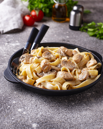 Fettuccine or tagliatelle pasta with chicken and mushroomの写真素材