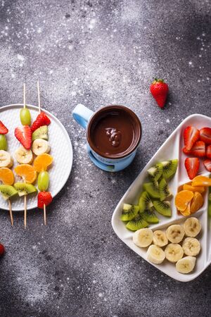 Sweet chocolate fondue with fruitsの写真素材