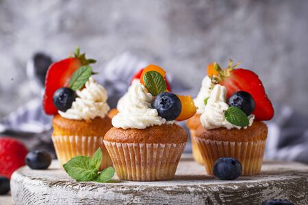 Cupcakes with cream and berriesの写真素材