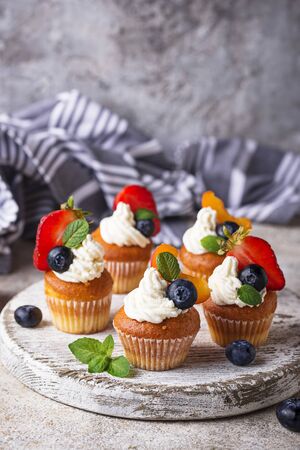 Cupcakes with cream and berriesの写真素材