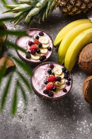 Dessert nice cream with  berry in coconut bowl. Breakfast in bedの写真素材