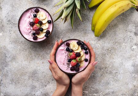 Acai bowl in coconut plate. Trendy healthy foodの写真素材