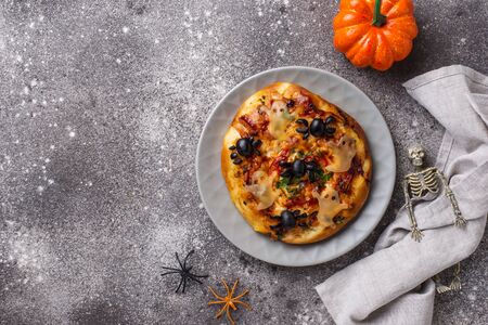 Halloween scary pizza decorated ghosts from cheese and spiderの写真素材
