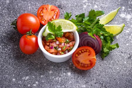 Traditional mexican tomato salsa sauce on wooden backgroundの写真素材
