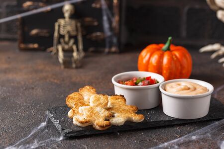 Bread in shape of men and sauces. Halloween scary appetizers.の写真素材