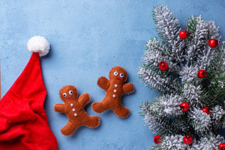 Christmas blue background with gingerbread men made of felt