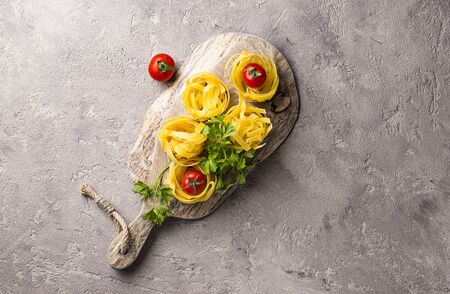 Raw uncooked homemade pasta tagliatelle or fettuccineの写真素材