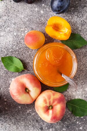 Homemade sweet apricot jam in glass jarの写真素材