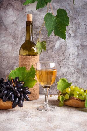 Grape, bottle and glass of white wine. Selective focusの写真素材