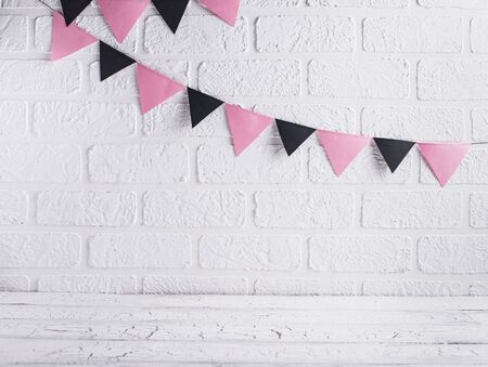 Decoration for Halloween. Paper pink and black garland on brick wallの写真素材