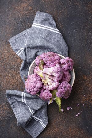 Raw dissected purple cauliflower on dark backgroundの写真素材