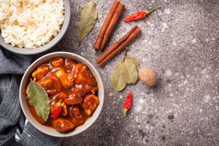 Curry chicken tikka masala with rice and spices
