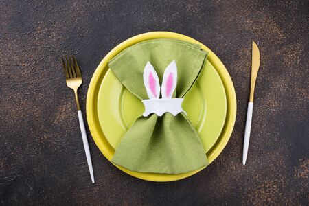 Easter table setting in green color with napkin holder in shape of bunny earsの写真素材