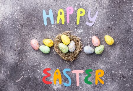 Happy Easter text and color eggs. Festive backgroundの写真素材