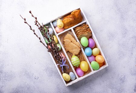 Box with Easter cookies and eggsの写真素材