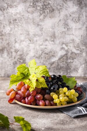 Assortment of different sort of grapes with leavesの写真素材