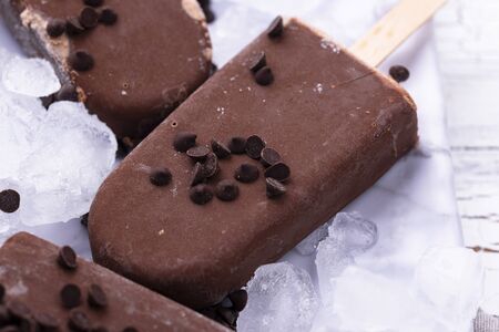 Chocolate ice cream  in glaze on whiteの写真素材