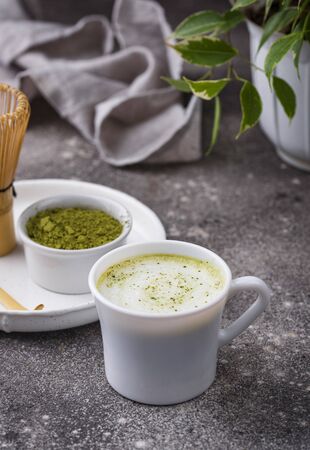 Green healthy matcha latte drink and bamboo tools for preparedの写真素材