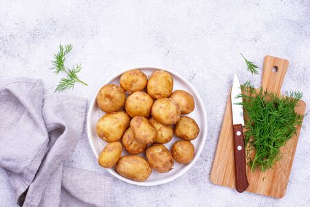 Young uncooked fresh potato and dillの写真素材