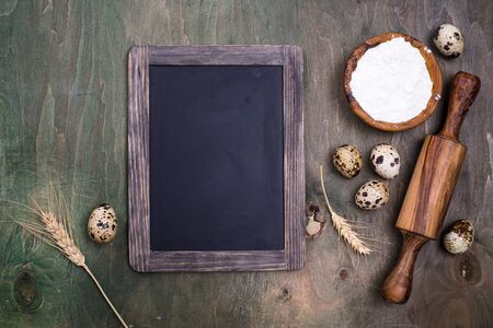 Baking concept with rolling pin on green wooden backgroundの写真素材