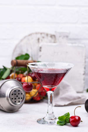 Red alcoholic cherry martini cocktail with shakerの写真素材